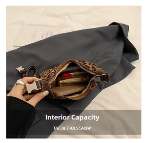 Detail view of leopard print crossbody bag showing interior storage for phone and lipstick