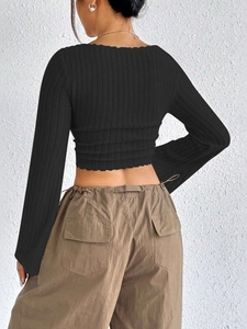 Rear view of black ribbed knit long sleeve crop top with square neck and flared sleeves