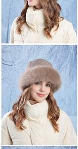 Close-up of khaki quilted trapper hat with faux fox fur trim for winter warmth