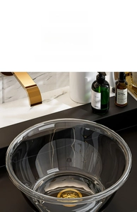 Close-up of clear PET washbasin with gold drain plug and heat-resistant material