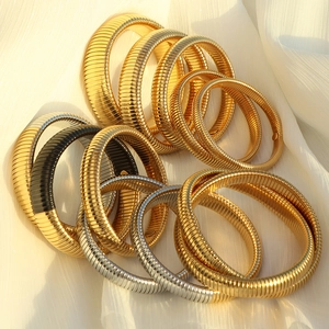 Vintage Tubogas style stretch bracelets in gold and silver finish on white silk