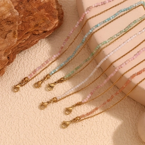Detailed macro view of colorful beads and 18K gold O-chains with lobster clasps