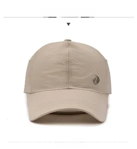 Detail of khaki quick-dry baseball hat with KT metal logo and premium stitched brim