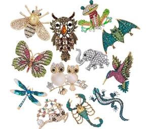 Set of 12 animal-shaped enamel brooches including owl frog and butterfly pins