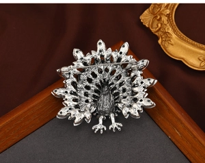 Macro detail of vintage silver turkey brooch back with secure pin and feather texture