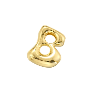 Macro shot of bubble letter B golden pendant with polished mirror finish for jewelry making