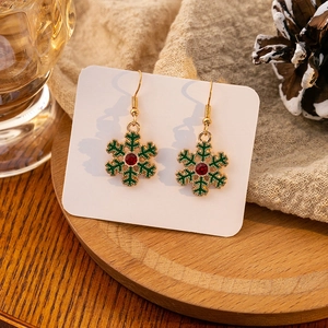 Elegant Christmas snowflake drop earrings with green enamel and red crystal in festive setting