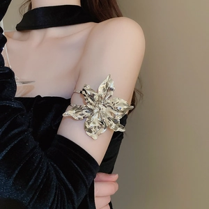Polished silver metal armlet featuring a large realistic floral design on upper arm