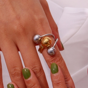 Detailed view of two-tone 18K gold and silver adjustable ring with polished triple beads