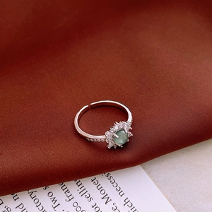 Macro shot of the vintage clover ring with cat-eye gemstone and micro-pave zircon detail