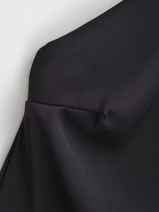 Detailed view of the smooth black satin fabric texture and premium stitching quality