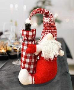 Close-up of a Christmas gnome wine bottle cover with red plaid and snowflake hat