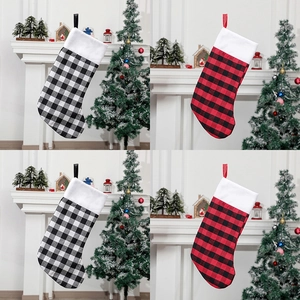 Detail of red and black buffalo plaid Christmas stockings with white faux fur trim and loops