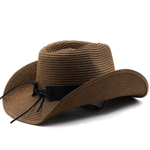Detail of dark brown straw western cowboy hat with black leather band and woven texture