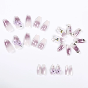 Detailed flat lay of 24pcs purple gradient press-on nails with 3D flowers and rhinestones