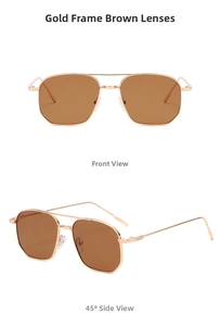 Close-up of golden metal double-bridge pilot sunglasses with brown tinted lenses