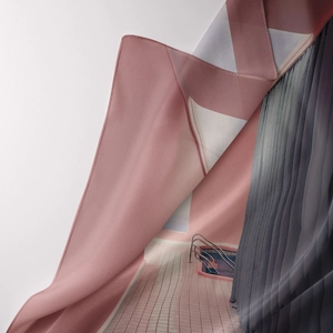 Close-up of surrealist architecture print on pink silk fabric with grey pleated details
