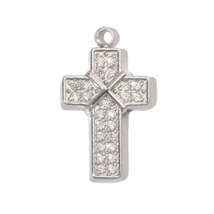 Macro detail of a silver cross pendant inlaid with small sparkling cubic zirconia stones