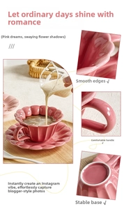 Detailed view of pink floral ceramic coffee cup with petal edges and ergonomic handle
