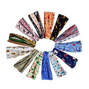 Flat lay of 12 yoga headbands with Halloween pumpkin and skull patterns on white background