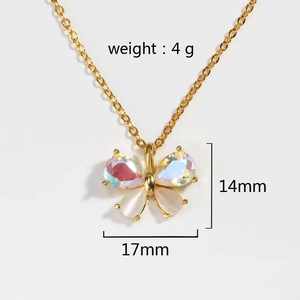 Detail view of gold butterfly pendant with iridescent stones and white shell inlay