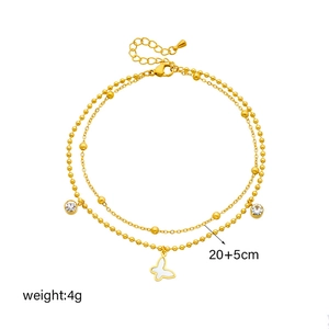 Golden double-layer anklet with butterfly pendant and crystal drops on white background