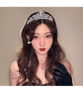 Close-up of elegant silver rhinestone crown with intricate filigree and crystal detailing