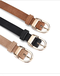 Detail view of brown black and beige women belts with golden D-ring metal buckles