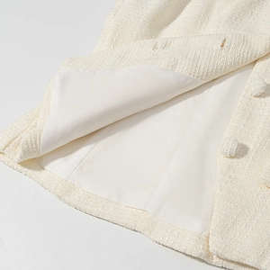 Dettaglio elegante giacca in tweed con fodera interna e bottone rivestito in tessuto