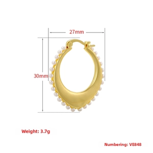 Detailed view of C-shaped gold earrings with pearls measuring 27mm x 30mm