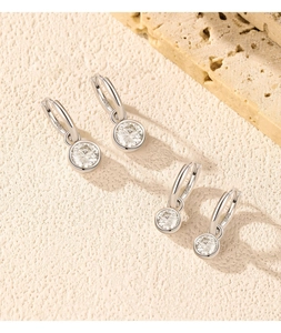 Close-up of S925 sterling silver hoop earrings with 1ct moissanite drop pendants