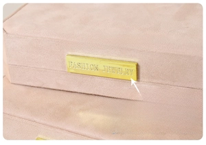 Detailed view of pink velvet jewelry box featuring a premium gold fashion metal plate