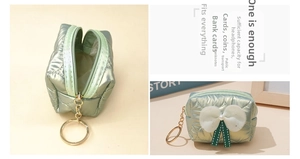 Macro detail of mint green quilted mini pouch with white polka dot bow and gold zipper