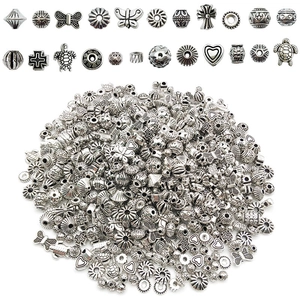 Macro shot of assorted antique silver charms in various shapes for DIY jewelry making