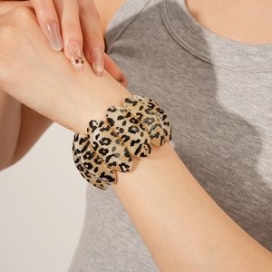 Close-up of leopard print resin bracelet featuring brown marbled tile link design