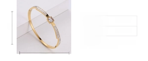 Macro detail of gold-plated bangle with square crystal inlay and zircon settings