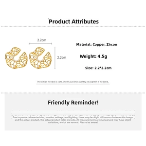 Close-up of gold hollow lattice stud earrings with white zircon on copper material