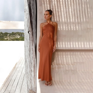 Detail of elegant backless halter neck satin maxi dress in rust orange with sleek fit
