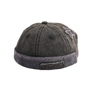 Vintage washed charcoal brimless docker cap with star patch and distressed cotton texture