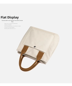 Minimalist canvas tote bag with brown handles and front pocket, perfect for daily casual use.