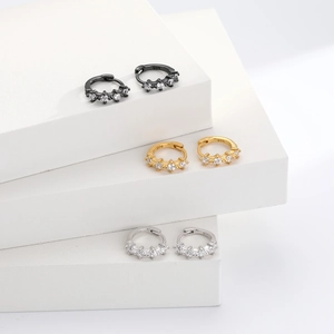 Three pairs of 925 sterling silver hoop earrings in black, gold, and silver with cubic zirconia