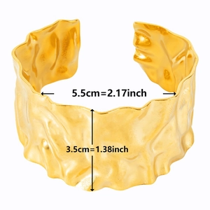 Detailed view of wide 18k gold plated stainless steel cuff with hammered texture and size