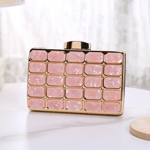 Detailed macro view of pink marble texture acrylic evening clutch with gold metal frame