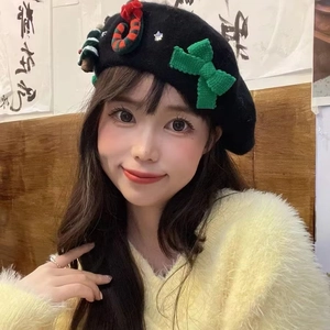 Black wool blend beret with green knit bow and festive Christmas decorations for women