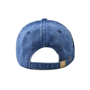 Detail of adjustable metal buckle on washed blue denim baseball cap with sewing textures