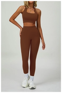 Macro shot of dark brown high-waist yoga pants and cropped halter sports bra set