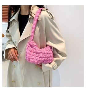 Close-up of pink bubble textured shoulder bag showing pleated knit fabric detail