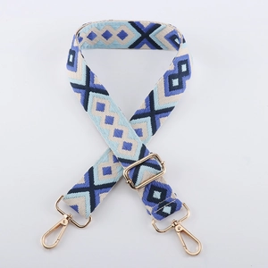 Detail of adjustable geometric diamond pattern bag strap with gold metal lobster hooks