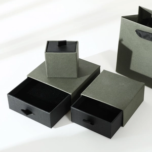Detailed view of various sizes of dark green drawer jewelry boxes and matching bag
