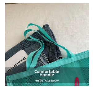 Detail shot of the mint green mesh tote bag with a focus on its durable webbed handles